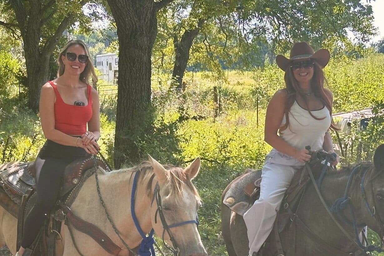 Abigail Horne with a guest enjoying a private ranch tour in Dallas, Texas, as part of a select Syndicate Global member experience, including UHNW founders, family office executives, and business leaders.