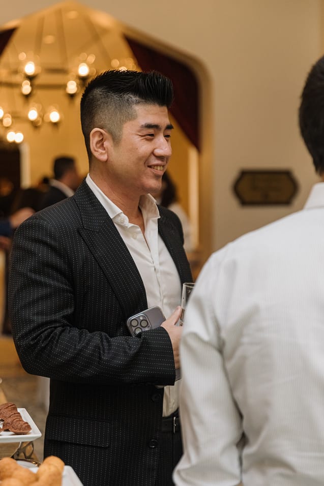 Smiling attendee enjoying The Syndicate Global luxury networking event in Dubai