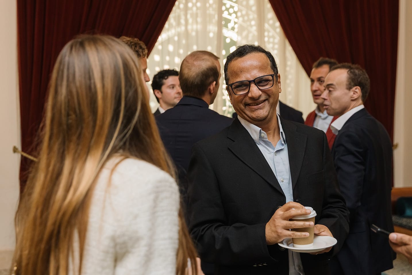 Smiling attendee enjoying The Syndicate Global luxury networking event in Dubai