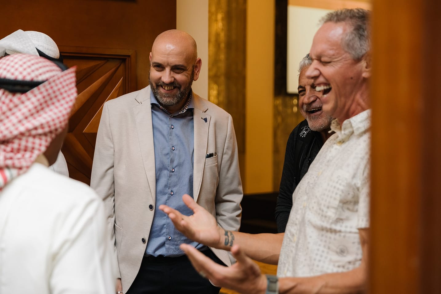 Charlie Engle and Steve Fowles laughing and speaking with attendees at The Syndicate Global luxury event in Dubai